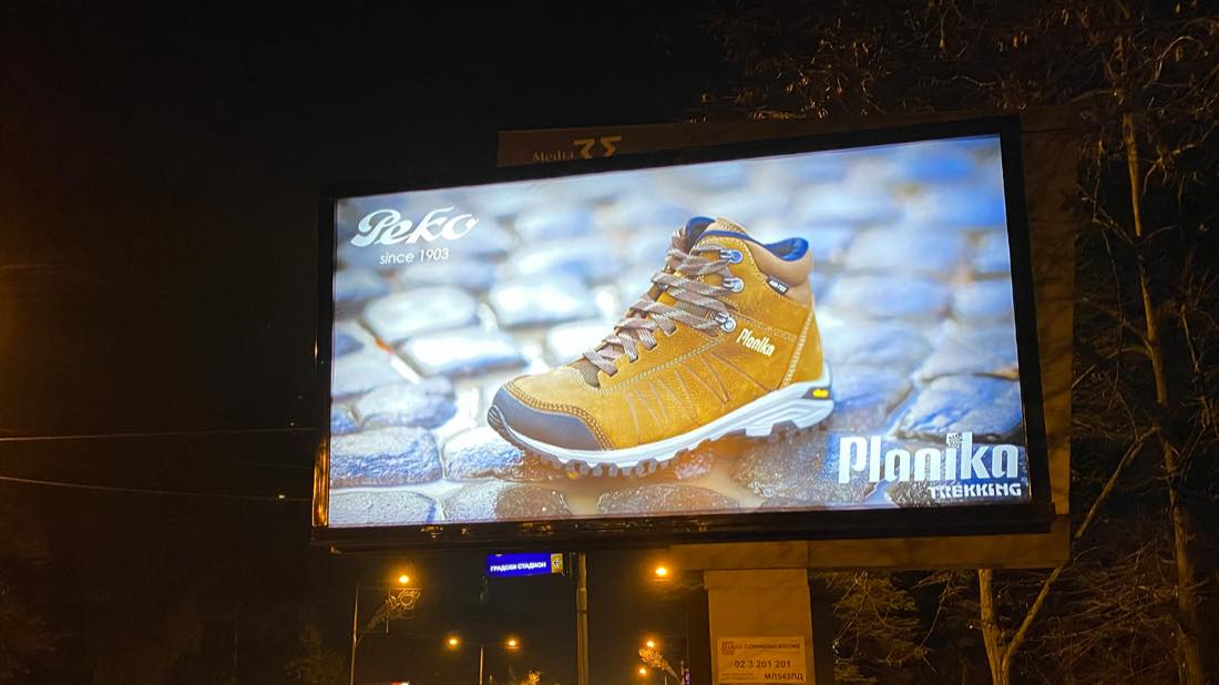 PEKO Planika Trekking billboard lit at night in Skopje